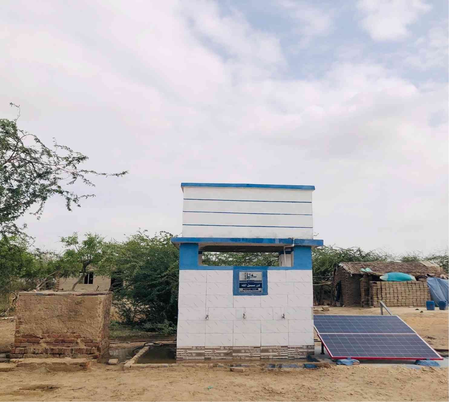 Family solar water project signage by Suqya Waters