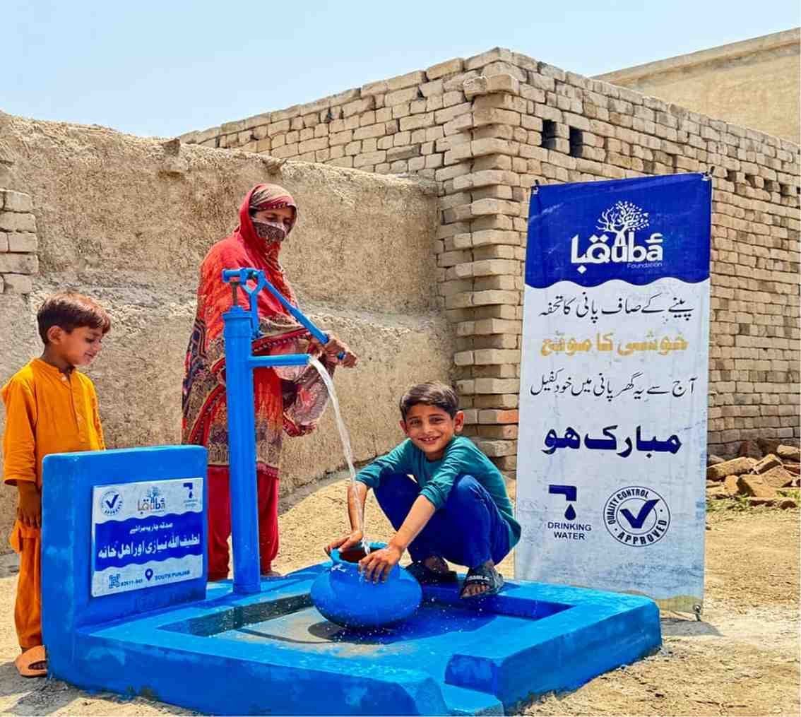 Boy filling water container at Suqya Waters installation